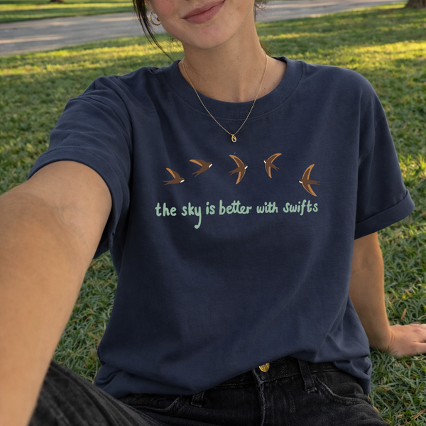 Model wearing a dark blue swift embroidered organic cotton T-shirt